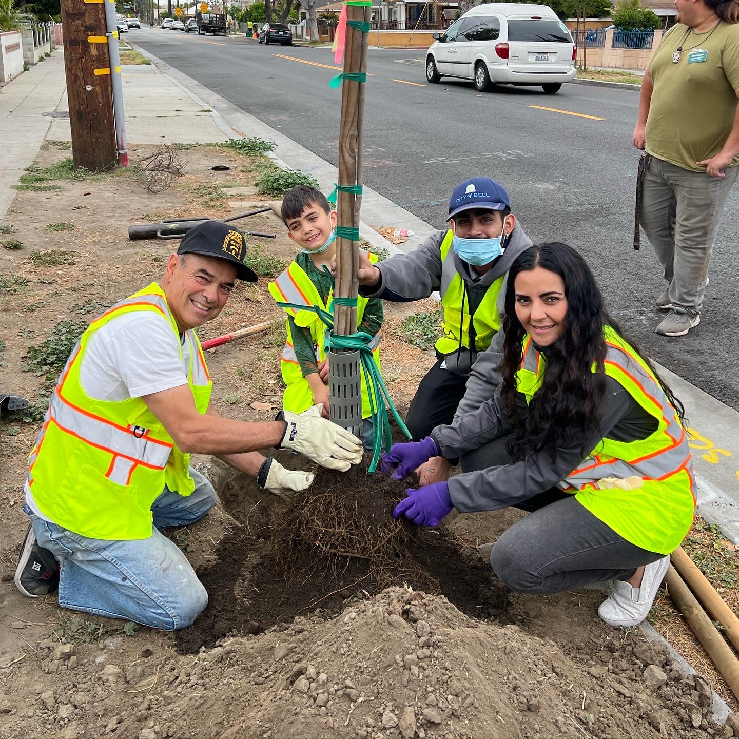 Councilmember Monica Arroyo joins in with a tree planting team in Bell, CA