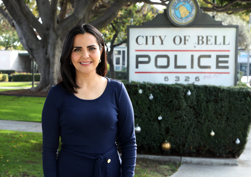 City Council Member Monica Arroyo in front of City of Bell Police sign